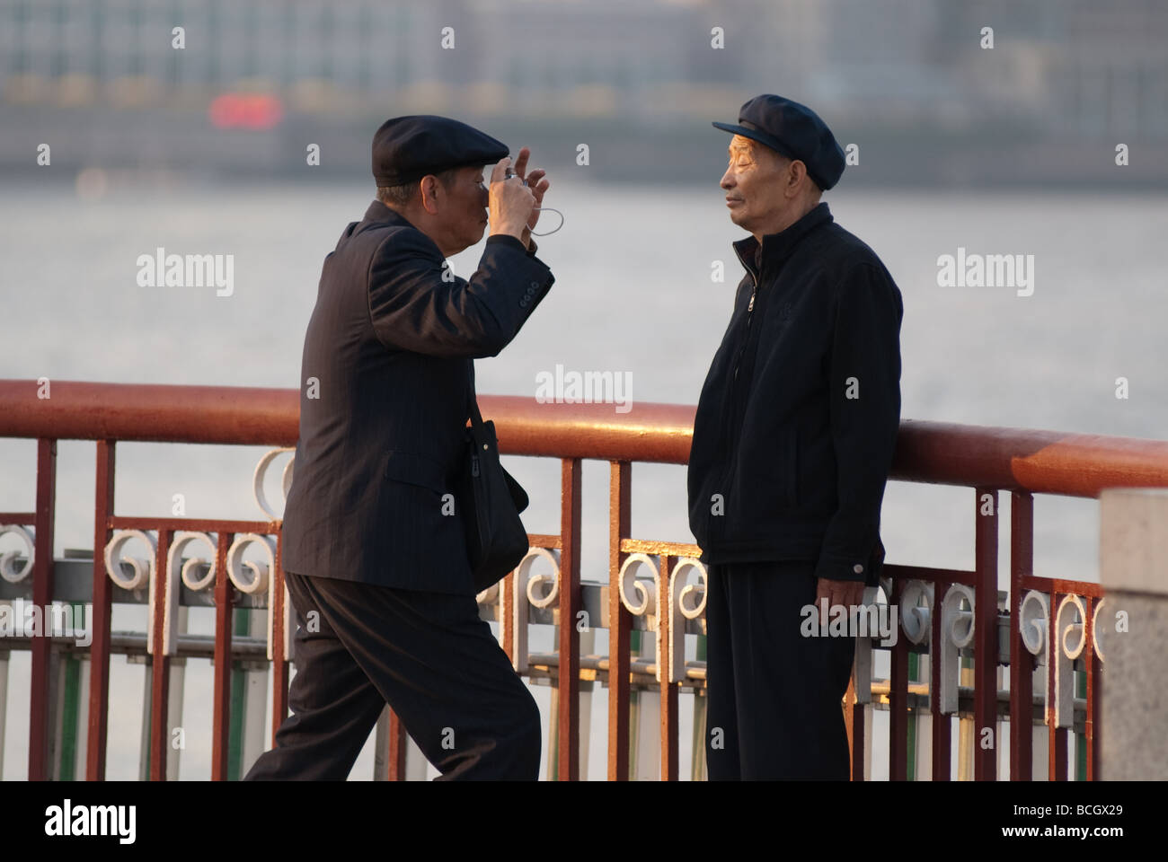 A man takes a picture at Bund Shanghai China Stock Photo