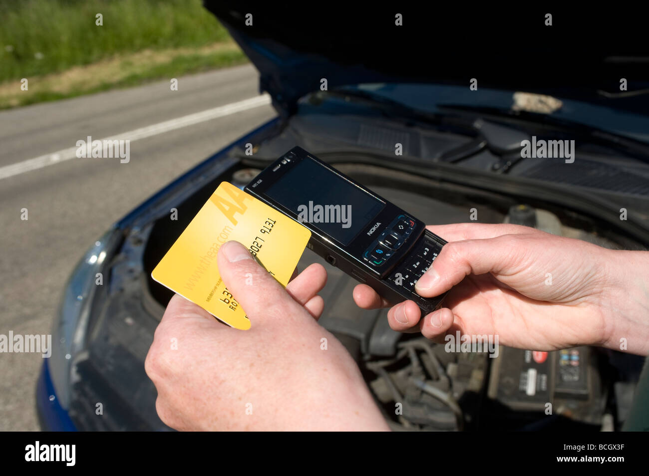 Close up of somebody using a mobile phone to ring the aa automobile association following a car breakdown Stock Photo