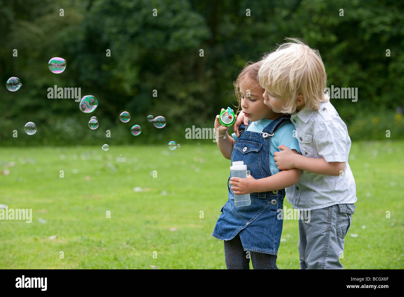 Two toddlers blowing bubbles Stock Photo Alamy