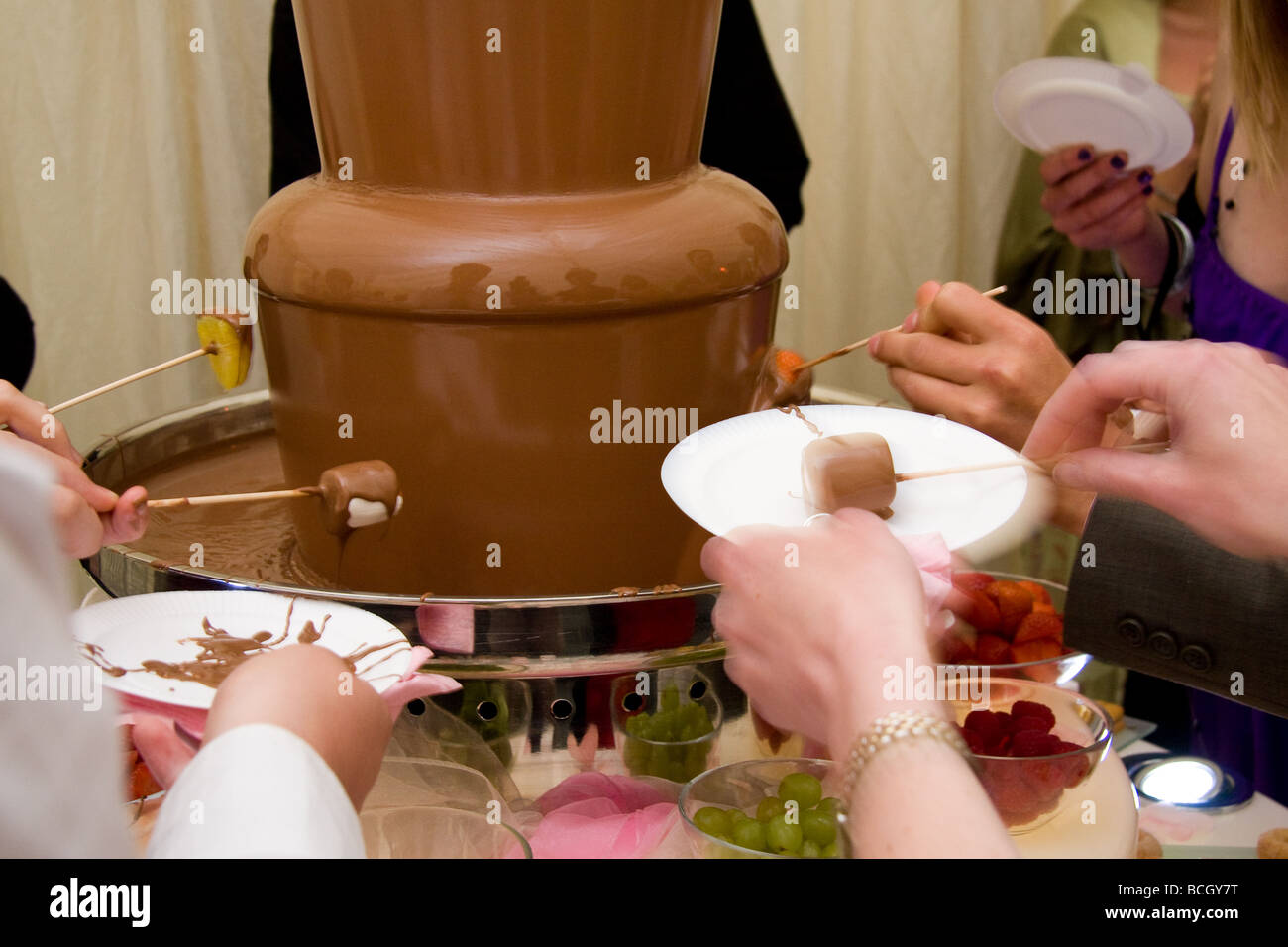 Chocolate fountain with accompaniments at a wedding inside a marquee Stock Photo