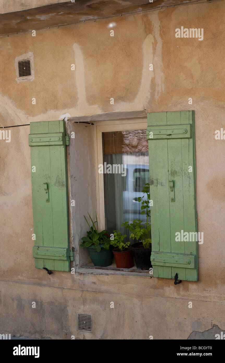 Old house with window sill and green shutters Avignon France Stock Photo