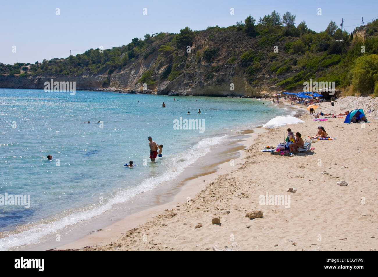 Tourists sunbathing and swimming on Trapezaki beach on the Greek island of Kefalonia Greece GR Stock Photo