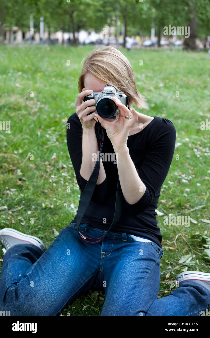 Portrait of a photographer shooting with a film camera, London, England, UK. Stock Photo