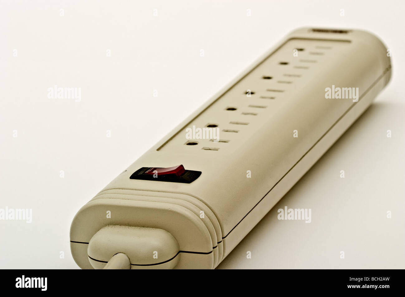 A surge suppressor with multiple outlets for plugs and a red switch Stock Photo