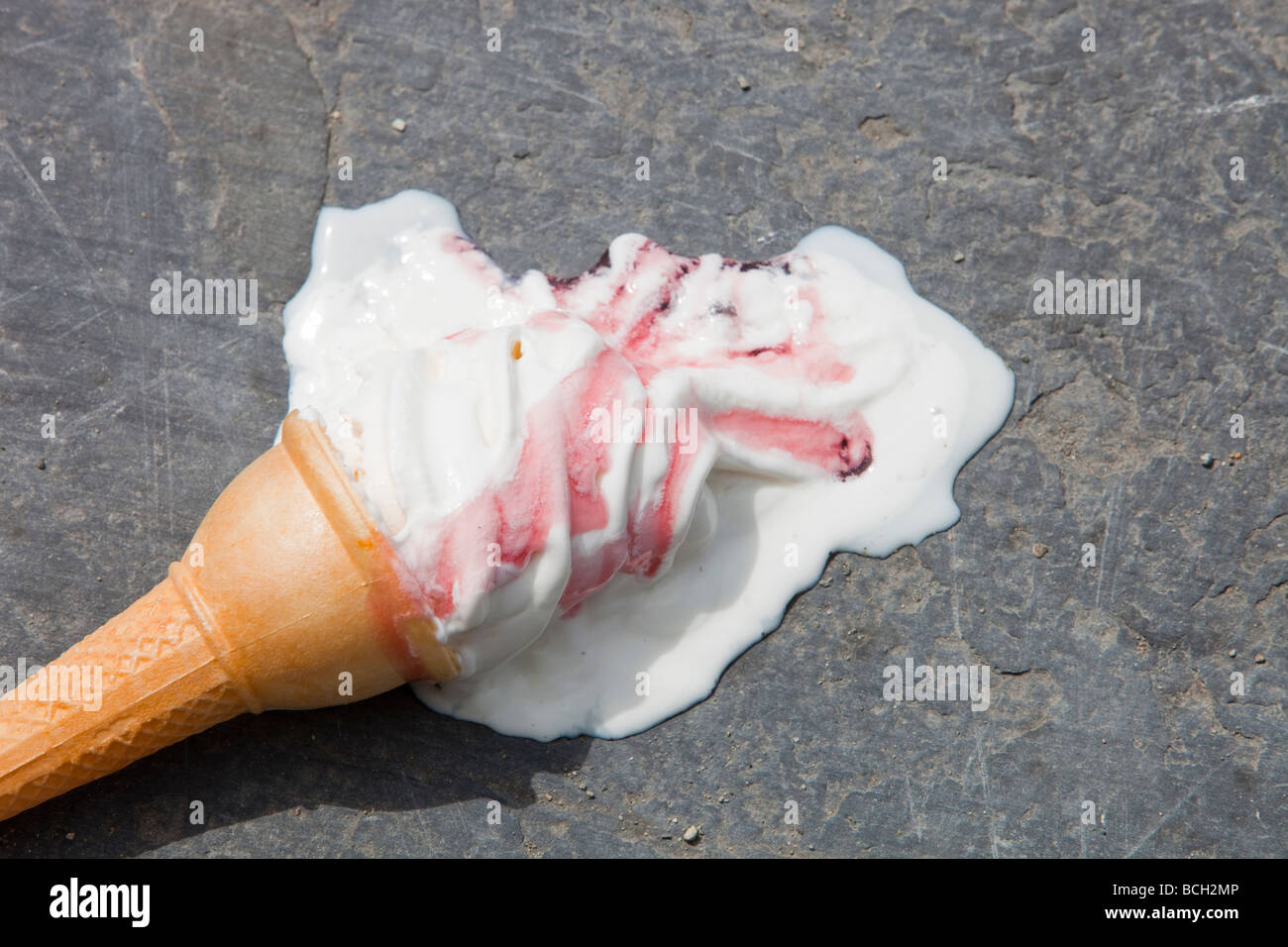 An ice cream melting on the shores of Lake Windermere Cumbria UK during a summer heat wave Stock Photo
