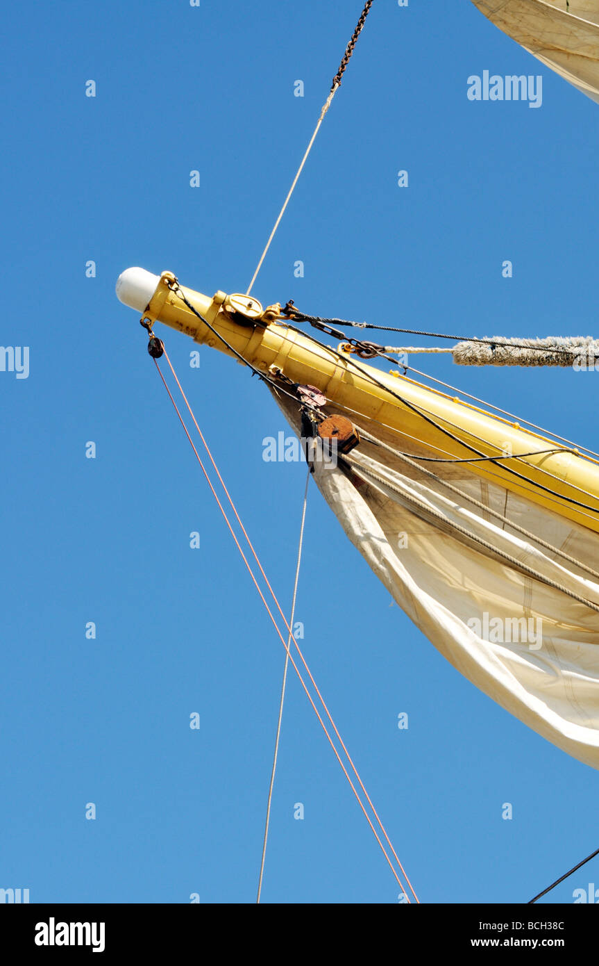 Yardarm of a tall ship with furled sail rigging and block and tackle Stock Photo