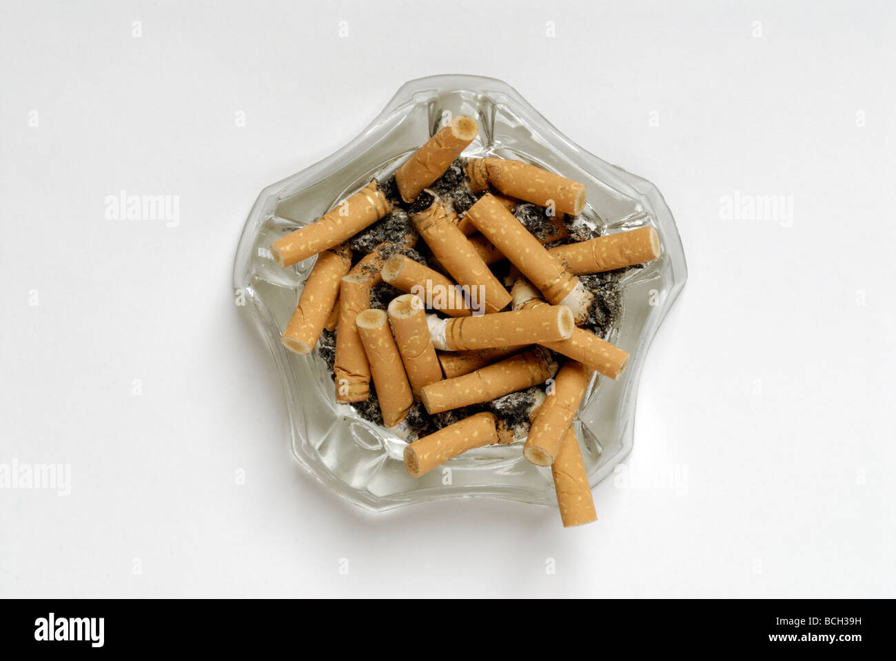 Glass ash tray full of cigarette butts without shadow Stock Photo Alamy