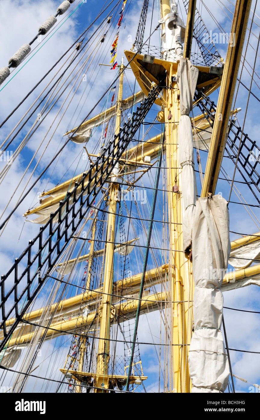 Looking aloft at Tall Ship mast with rigging shrouds and furled sails Stock Photo