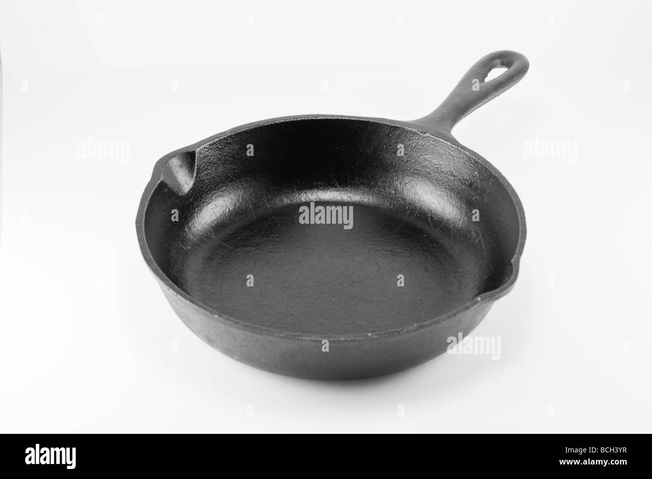 Black cast iron old skillet isolated on white Stock Photo Alamy