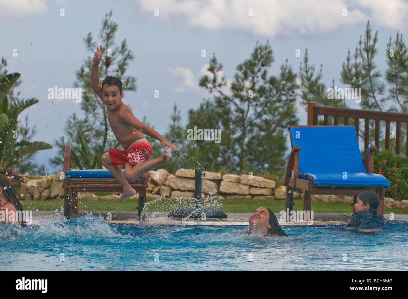Children having fun in the sun - poolside joy in Cyprus Stock Photo