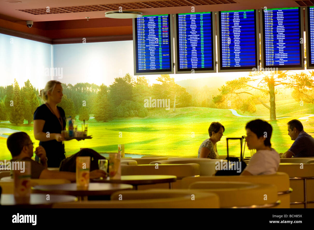 Passengers relax before departure at the cafe bar at Fryderyk Chopin Airport Warsaw Poland Stock Photo