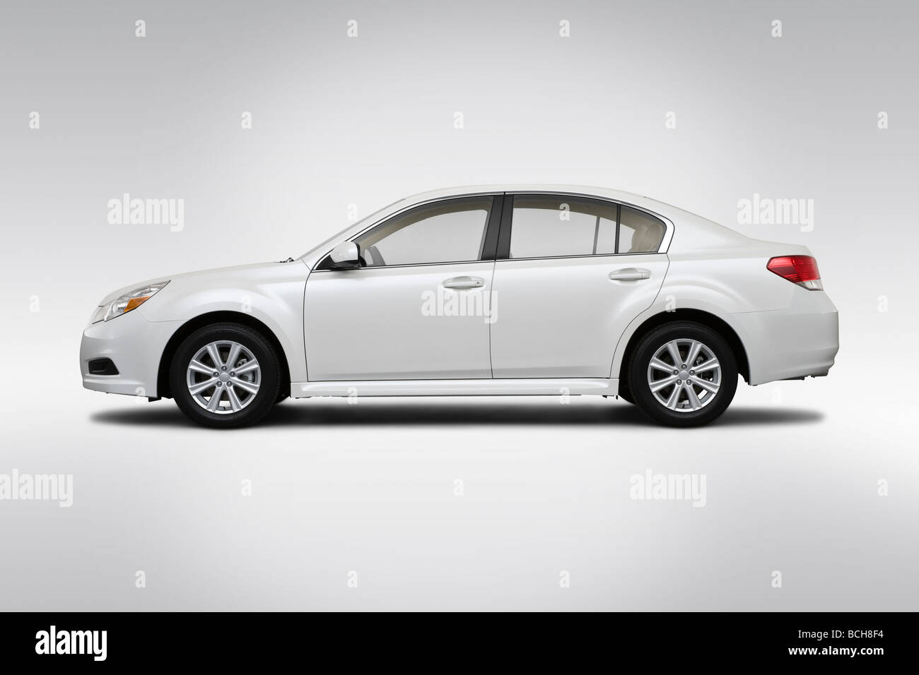 2010 Subaru Legacy 2.5i in White - Drivers Side Profile Stock Photo