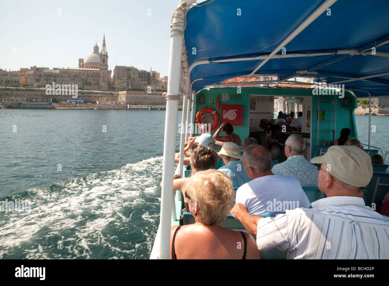 Passengers on the Sliema to Valletta ferry view the Carmelite Church, Valletta, Malta Stock Photo