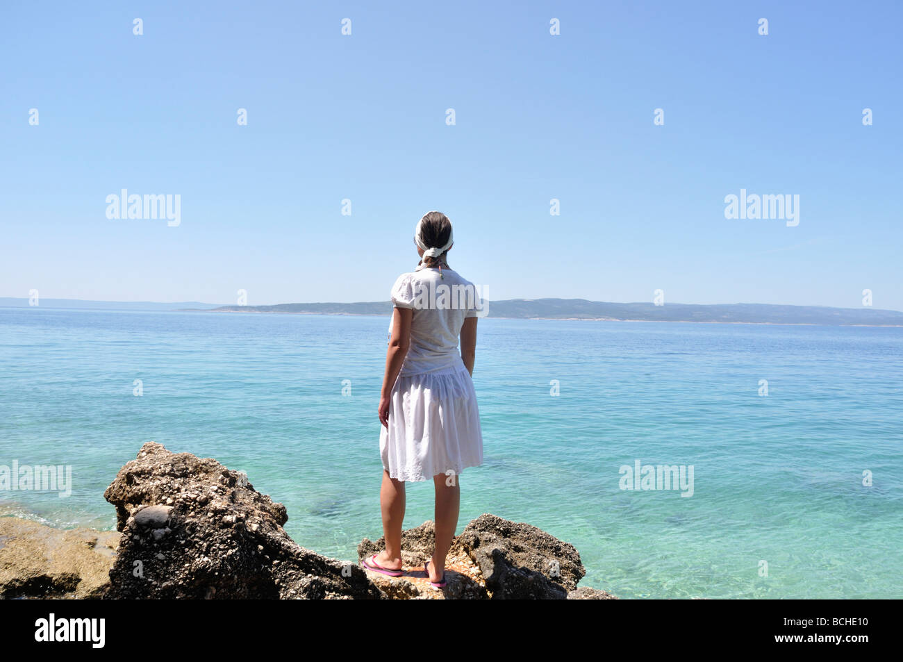 Woman standing on rocks looking hi-res stock photography and images - Alamy