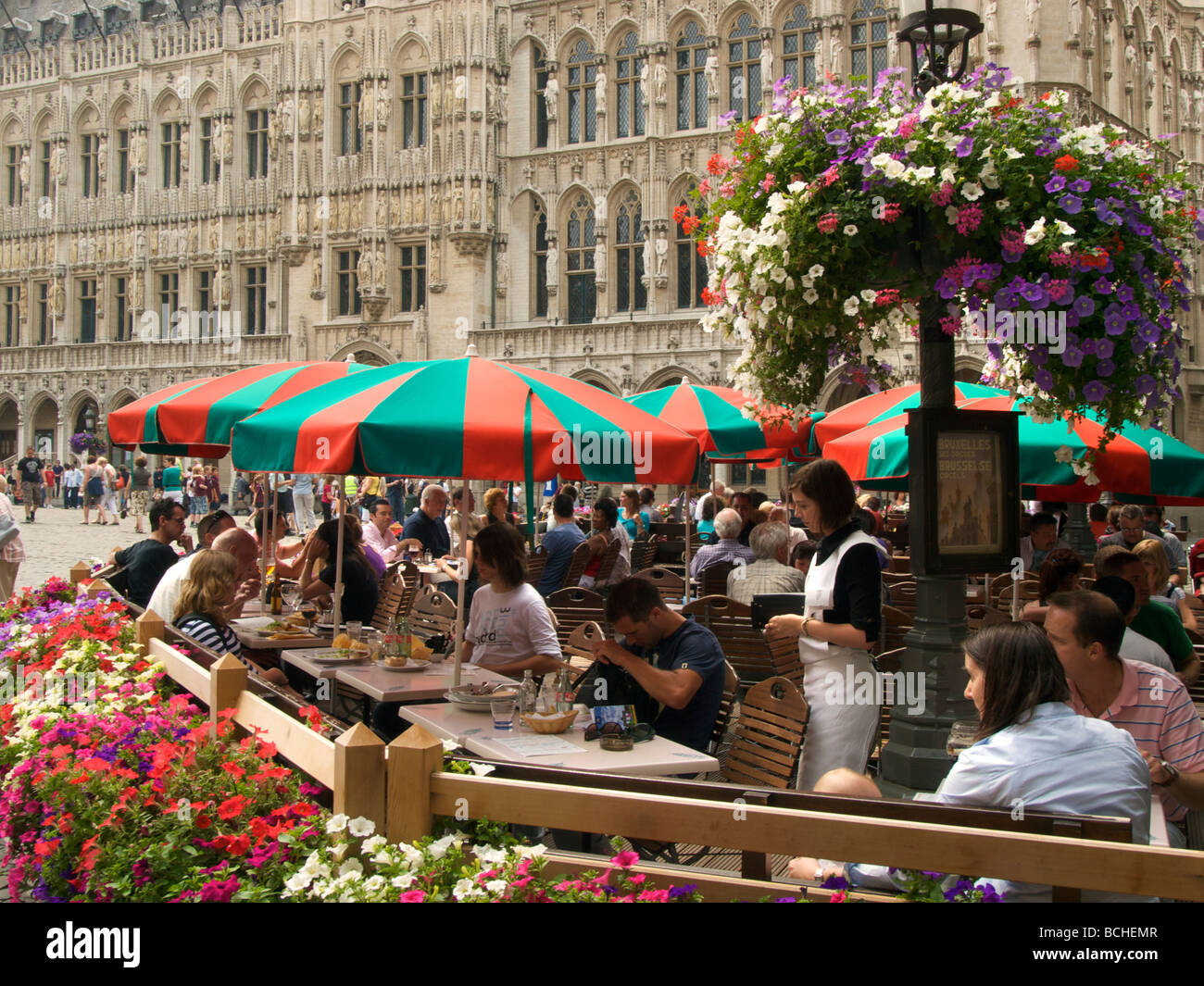 people having a drink and enjoying the 17th century scenery on the Grote Markt main square in Brussels Belgium Stock Photo