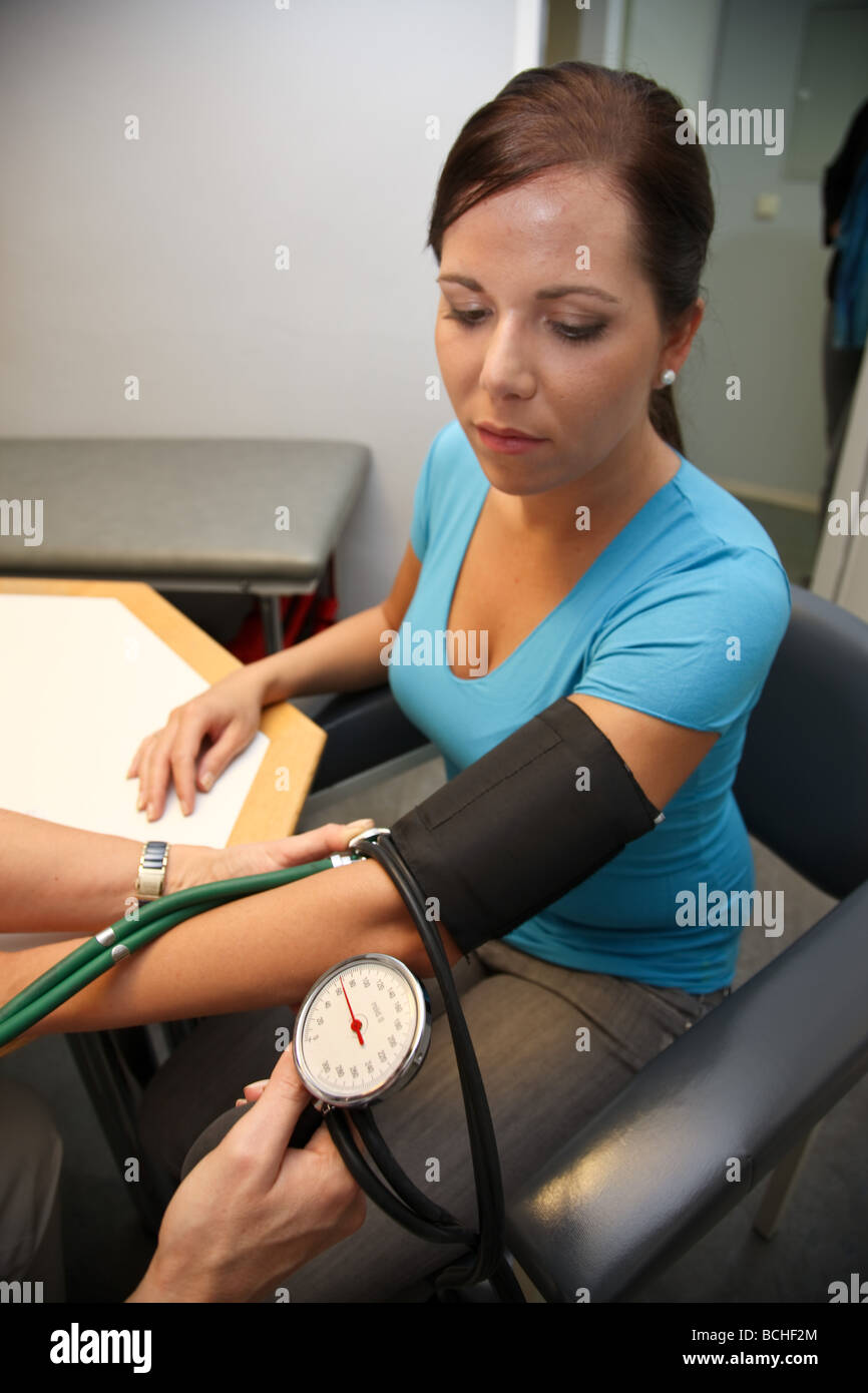 Physician with stethoscope measures blood pressure of a patient Stock ...