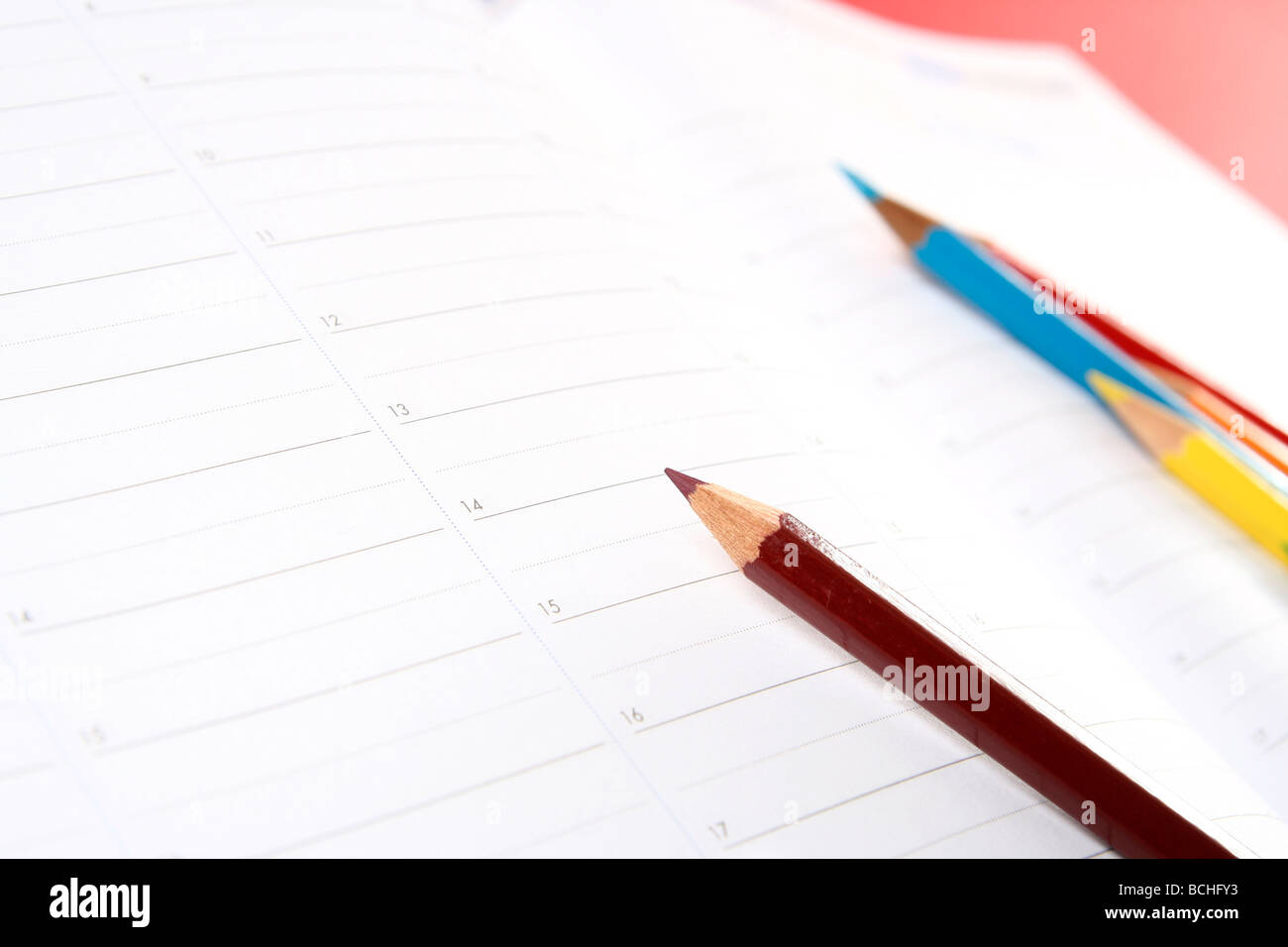 Close-up of color pencils and agenda Stock Photo