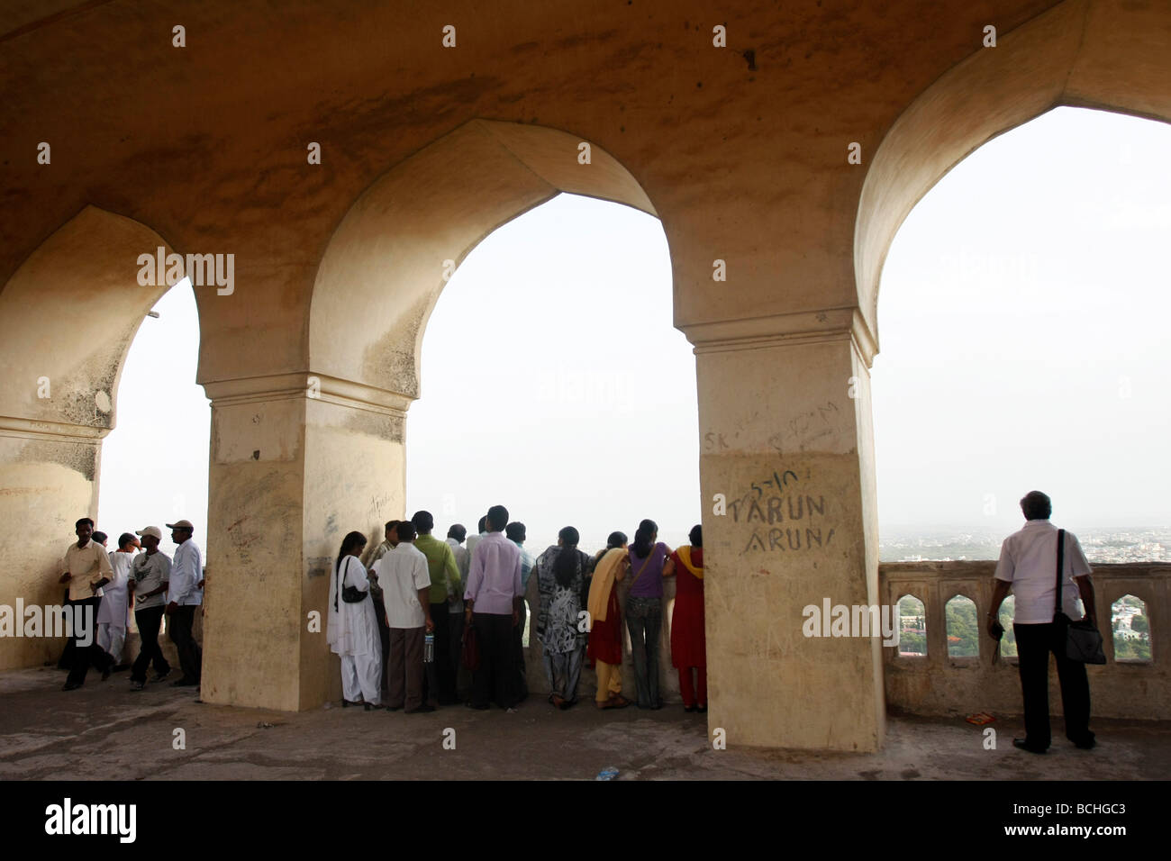 Indian tourists observe the view from the Golconda Fort in Hyderabad in India. Stock Photo
