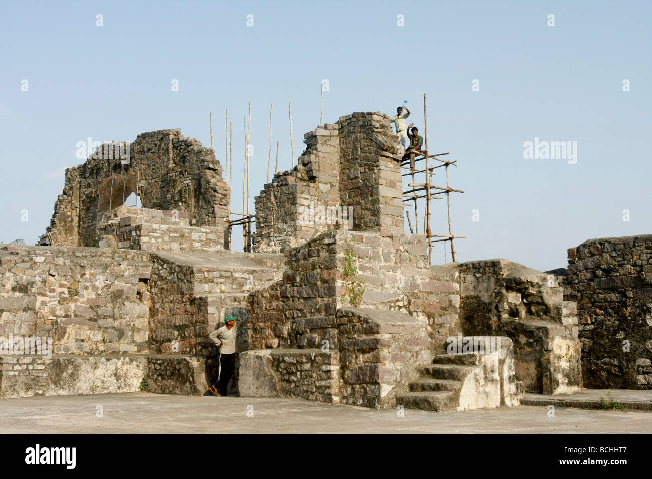 Indian men work to restore the historical Golconda Fort in Hyderabad in India Stock Photo
