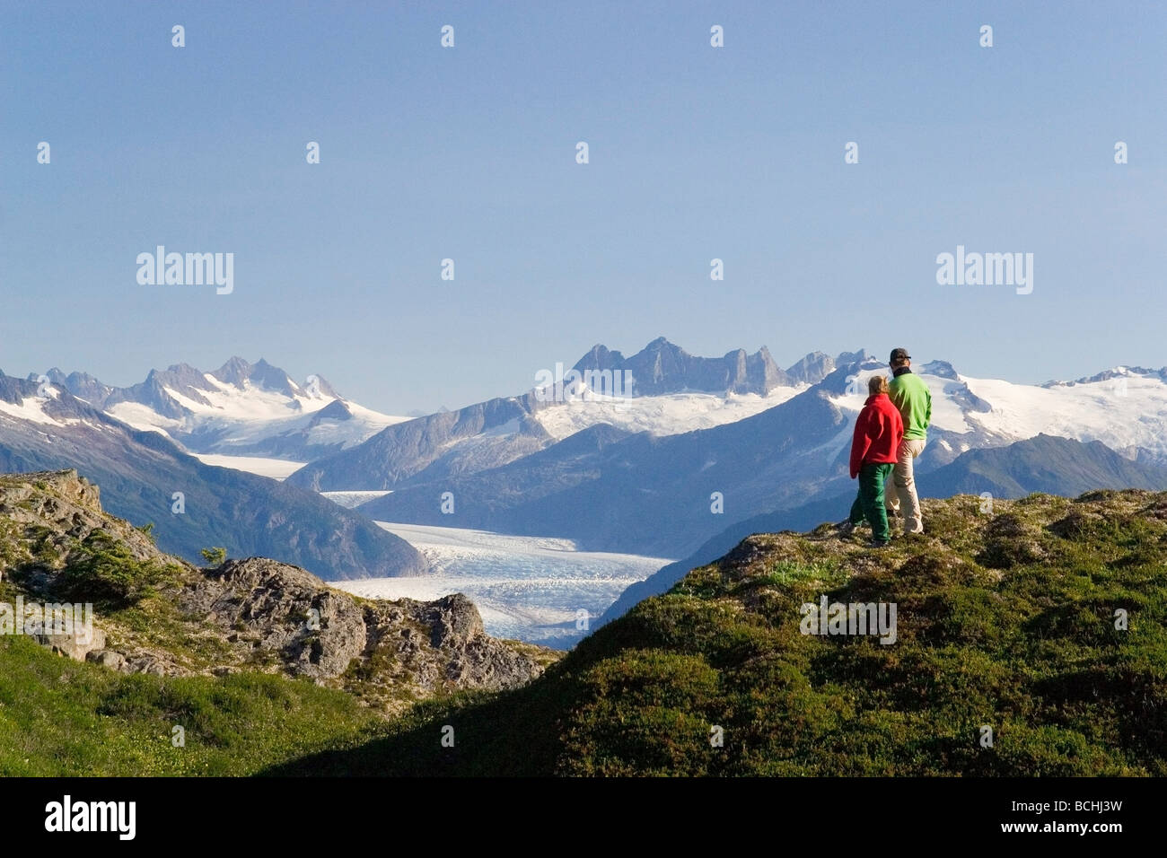 Couple hiking near Mendenhall Glacier Tongass National Forest Alaska Southeast Stock Photo