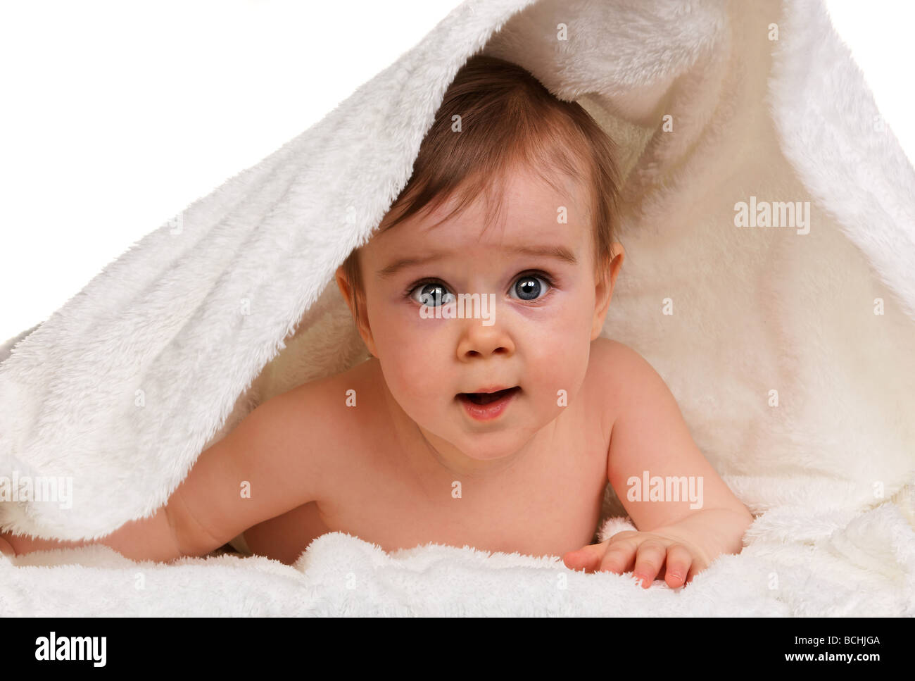 Small astonished child baby wrapped in blanket Stock Photo Alamy