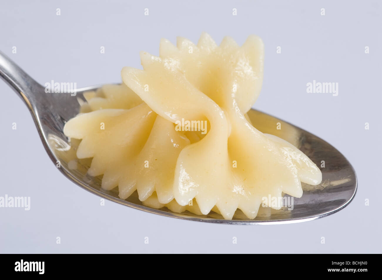 Ferfle Spoon Farfalle in a spoon Stock Photo - Alamy