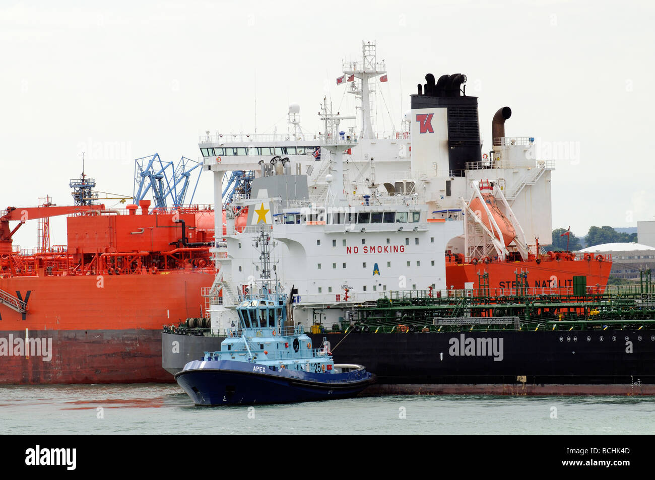 Marine Terminal Fawley Southampton UK crude oil tanker T C Glenisner being manoeuvred onto a berth by tug Apex Stock Photo