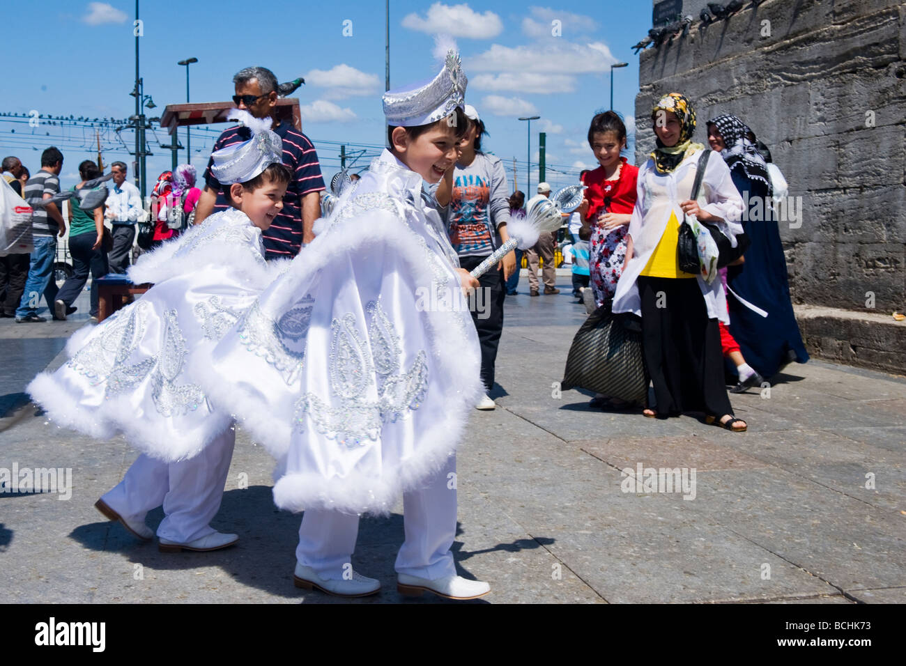 sunnet Turkey , Istanbul , New Mosque or Yeni Cami , young brothers play in sunnet  or circumcision costumes watched by proud mother Stock Photo - Alamy
