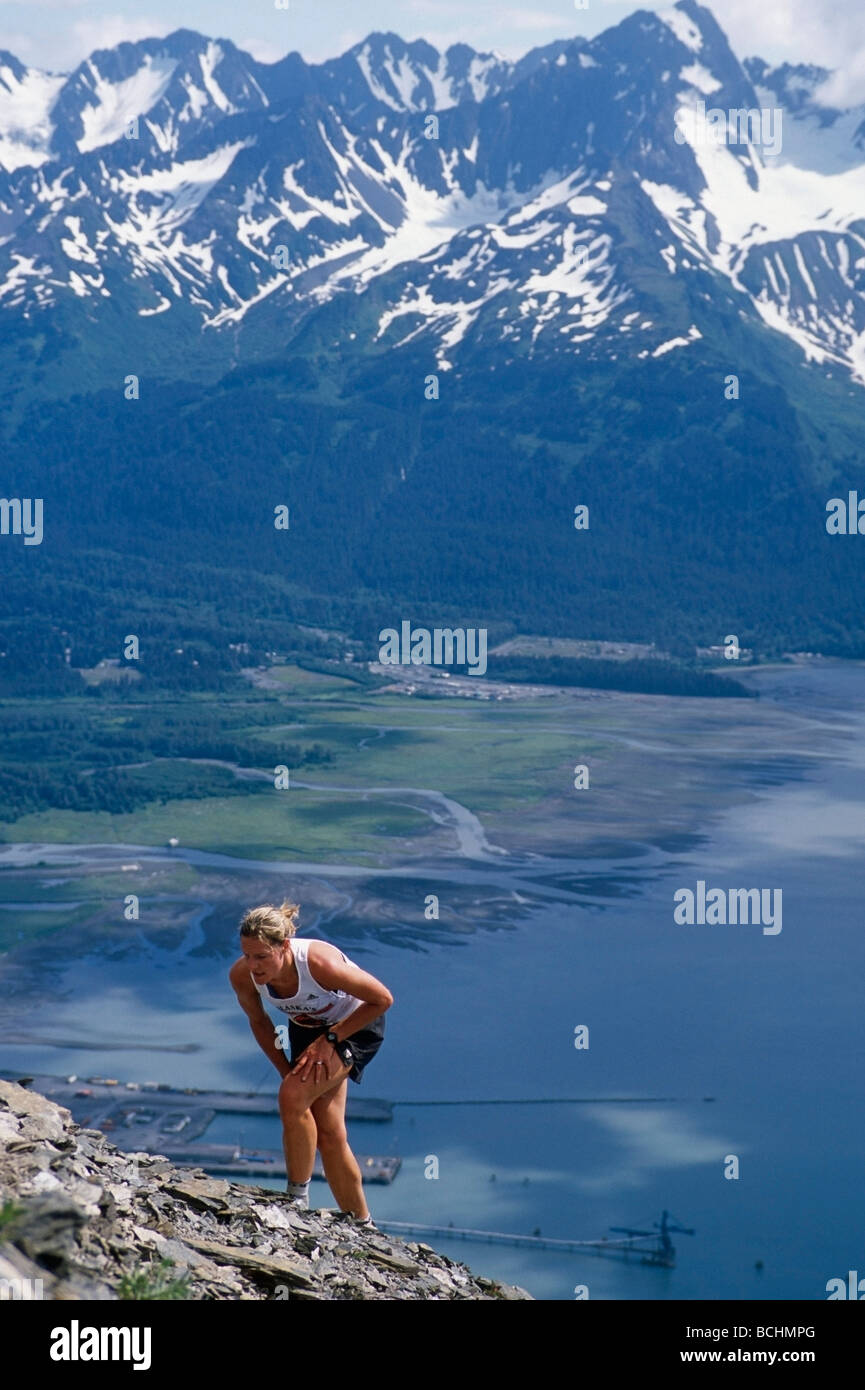Female competitor runs up Mount Marathon during race Seward Alaska
