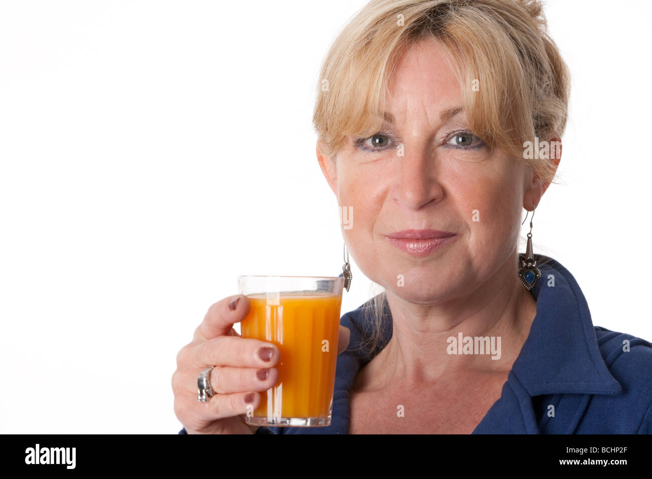 Senior woman with a glass of orange juice Stock Photo