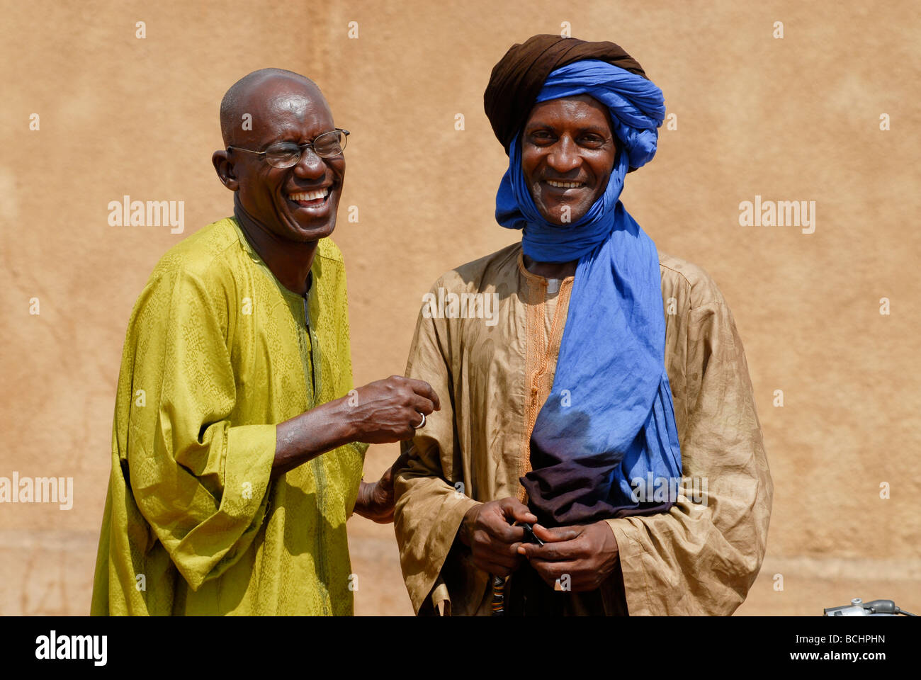 Western Africa , Mali , two men have a talk in village, the wear a boubou made from damask fabric Stock Photo