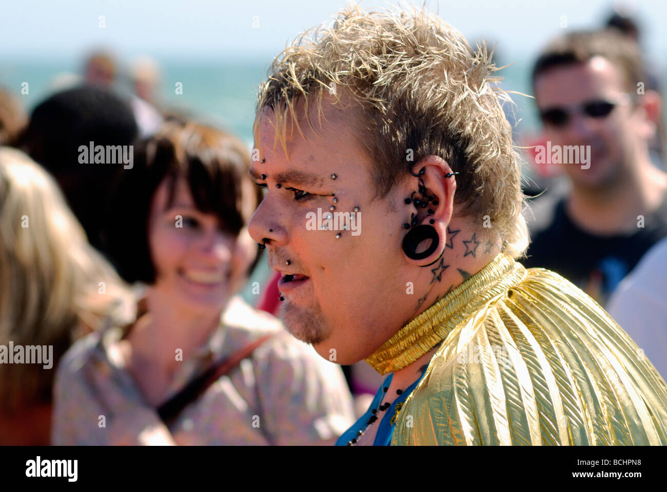 Man with tattoos and piercings in street parade Stock Photo