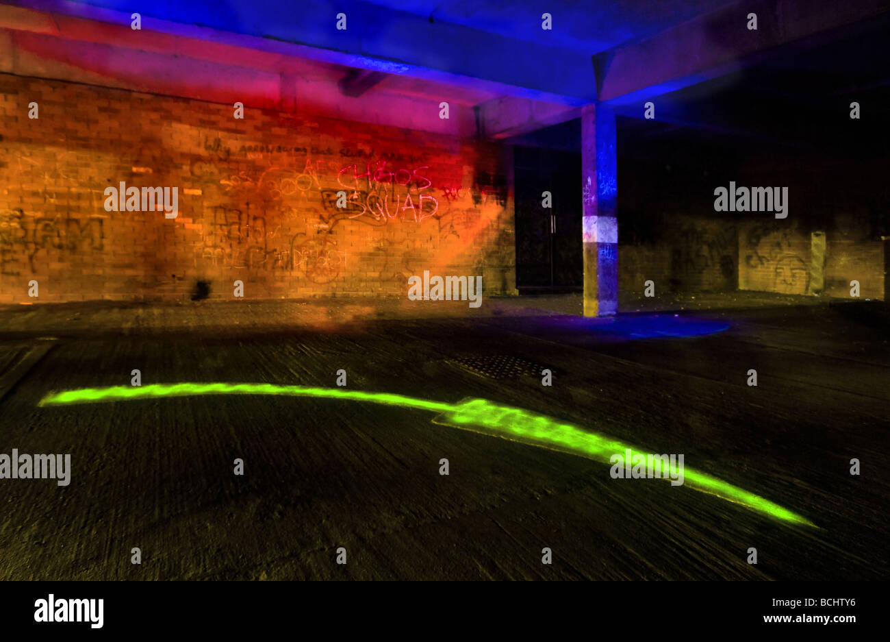 Urban Directions - A dark underground car park painted with colored light Stock Photo
