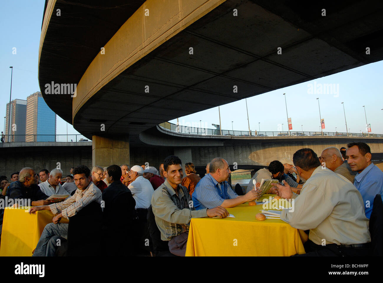 Poor people in Cairo are waiting for Iftar, the breakfast at sunset during the holy month of Ramadan Stock Photo