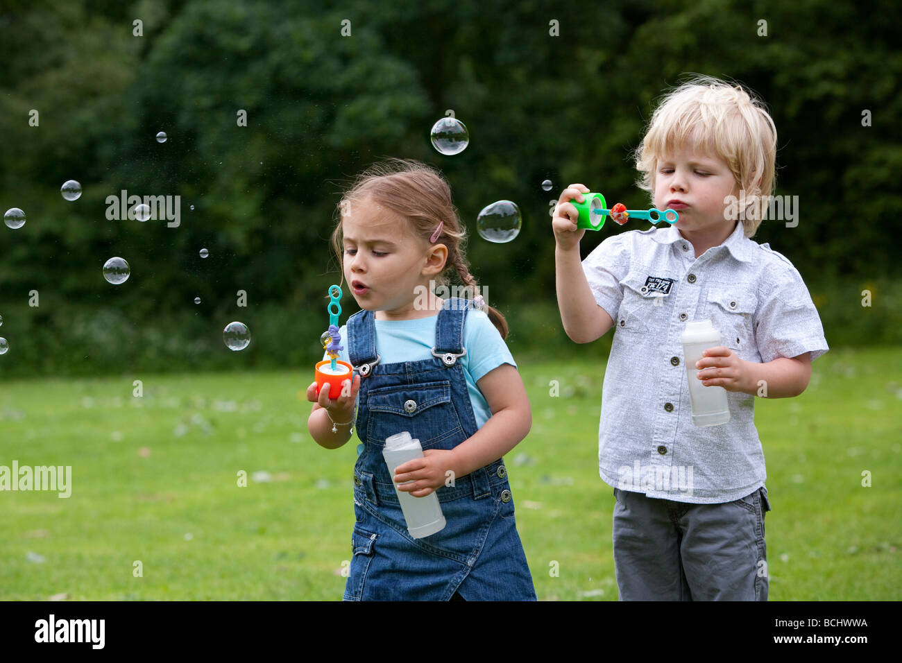 Two toddlers blowing bubbles Stock Photo Alamy