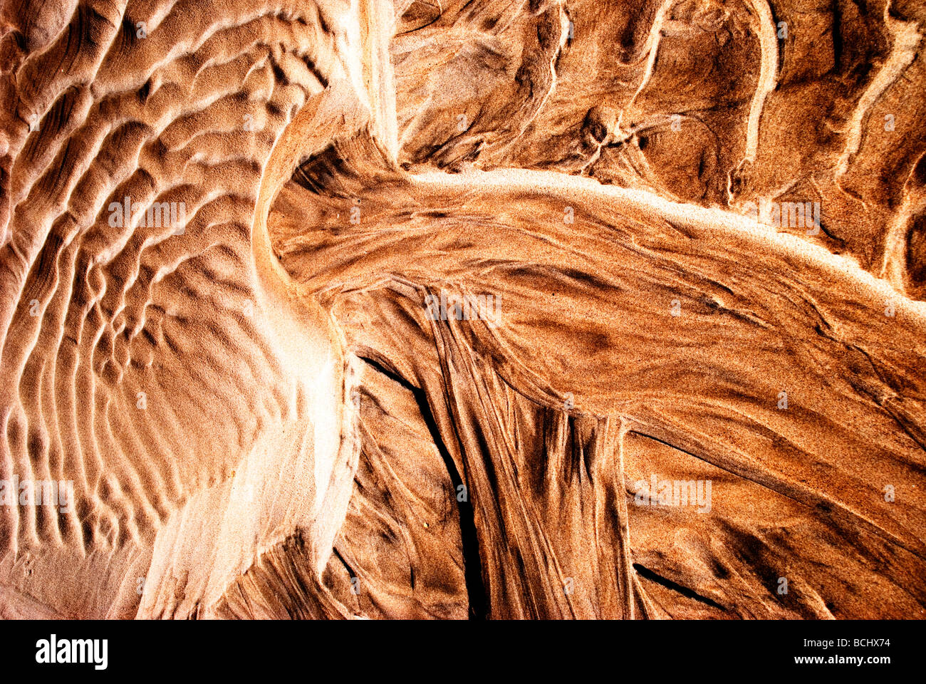 Patterns created by sea water tide and wind on an Atlantic coast beach Stock Photo