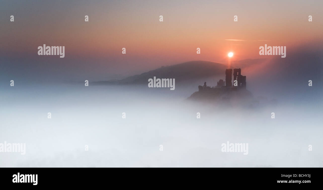 Corfe Castle shrouded in early morning mist Purbeck Dorset South West England UK Castle Stock Photo