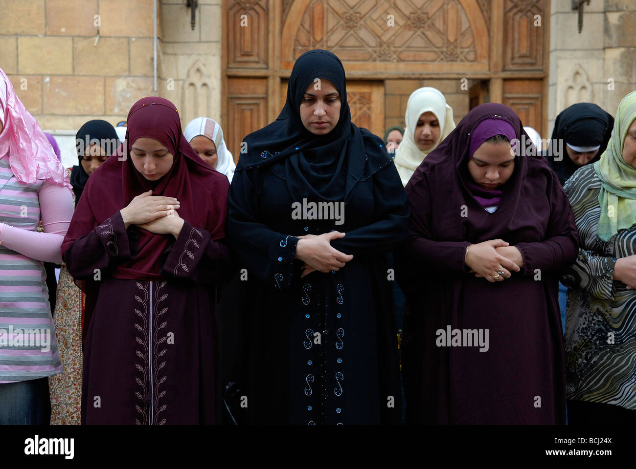 Egyptian Muslim women praying at the end of the holy fasting month Ramadan in Hussein Mosque in Khan Al Khalili area in Cairo Stock Photo