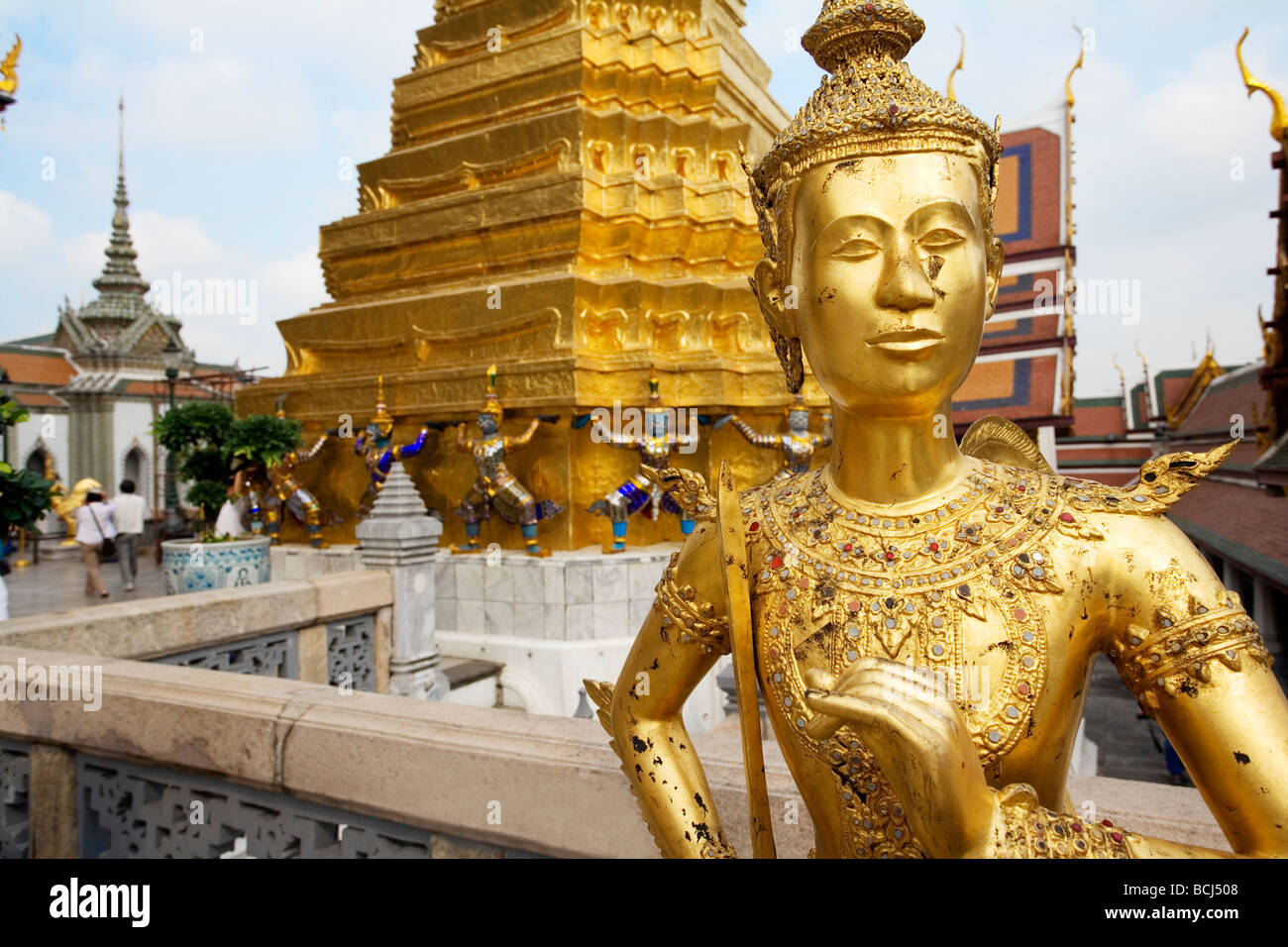 Golden statue within the gates of the Grand Palace in Bangkok Thailand Stock Photo