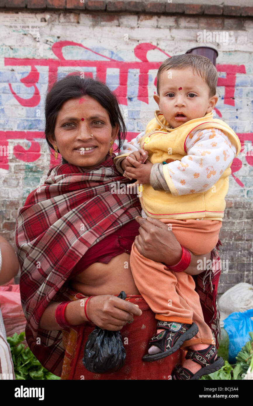 Kathmandu, Nepal. Micro-credit Loan Recipient Poses in the Market with her Son. Stock Photo