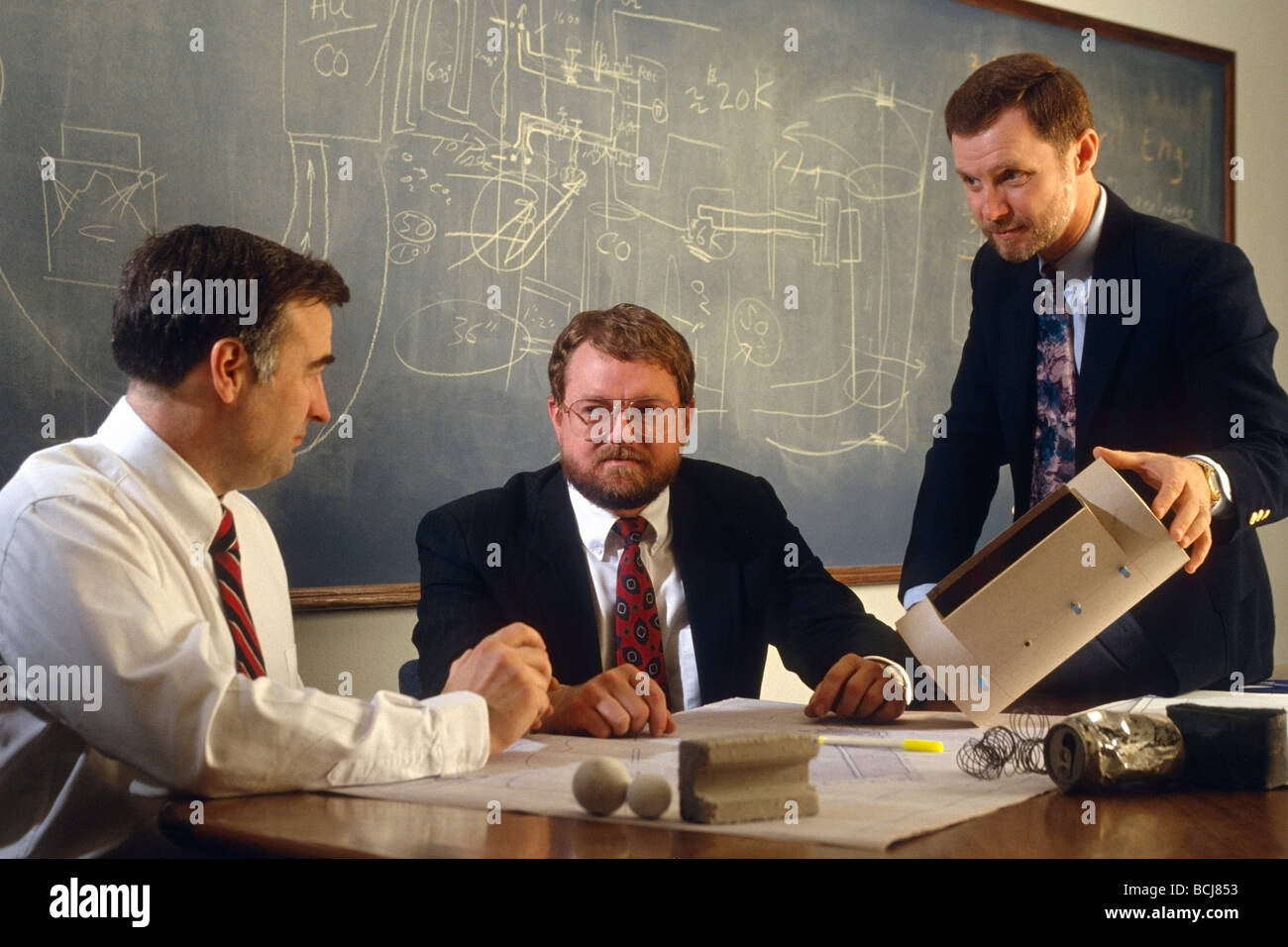 Businessmen Meeting in Engineering Office at Desk Stock Photo