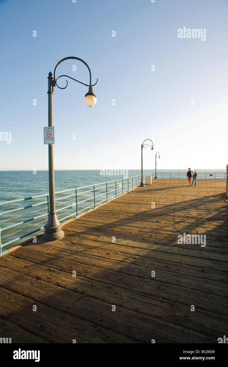 Male and female couple walking on Santa Monica Pier in Santa Monica, California, USA Stock Photo