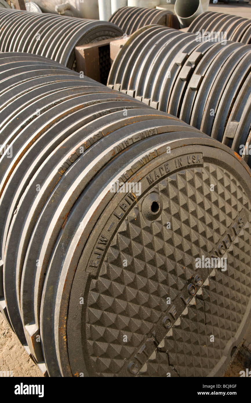 Stack of circular cast iron manhole covers Stock Photo