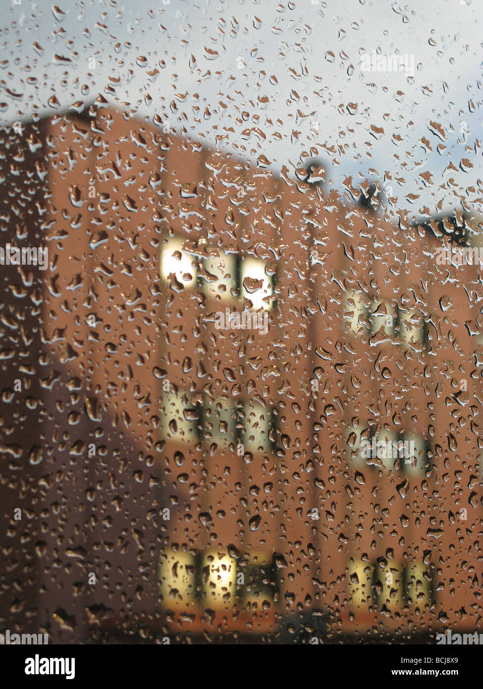 modern office block seen through rain drops covered window Stock Photo ...
