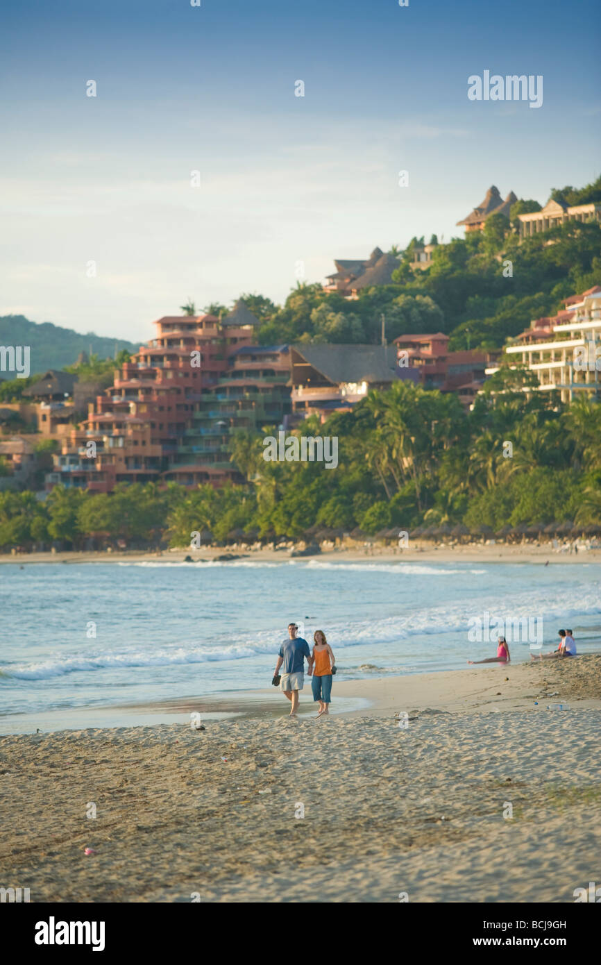 Zihuatanejo Mexico Male and female couple walking on beach of Playa La Madera in Zihuatanejo Mexico Stock Photo