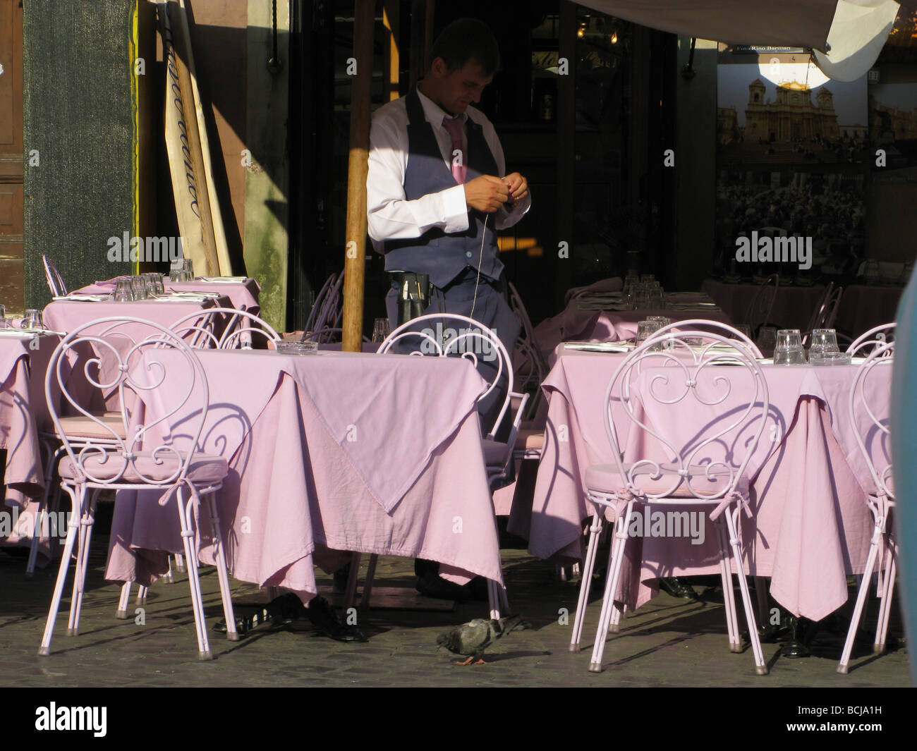 waiter in empty restaurant in piazza navona, rome Stock Photo