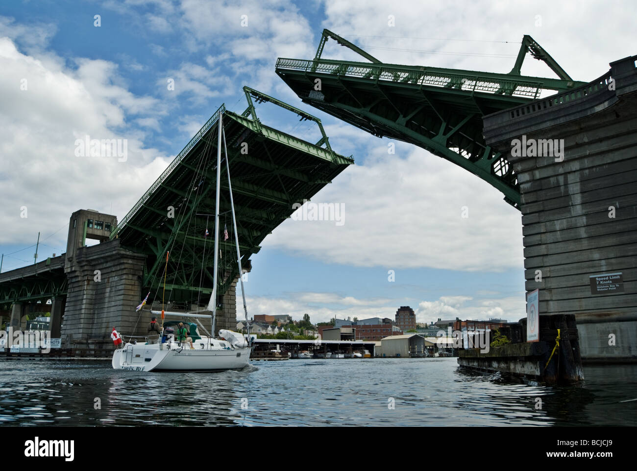 A sailboat passes under the Eastlake Avenue draw bridge in Seattle, Washington. Stock Photo