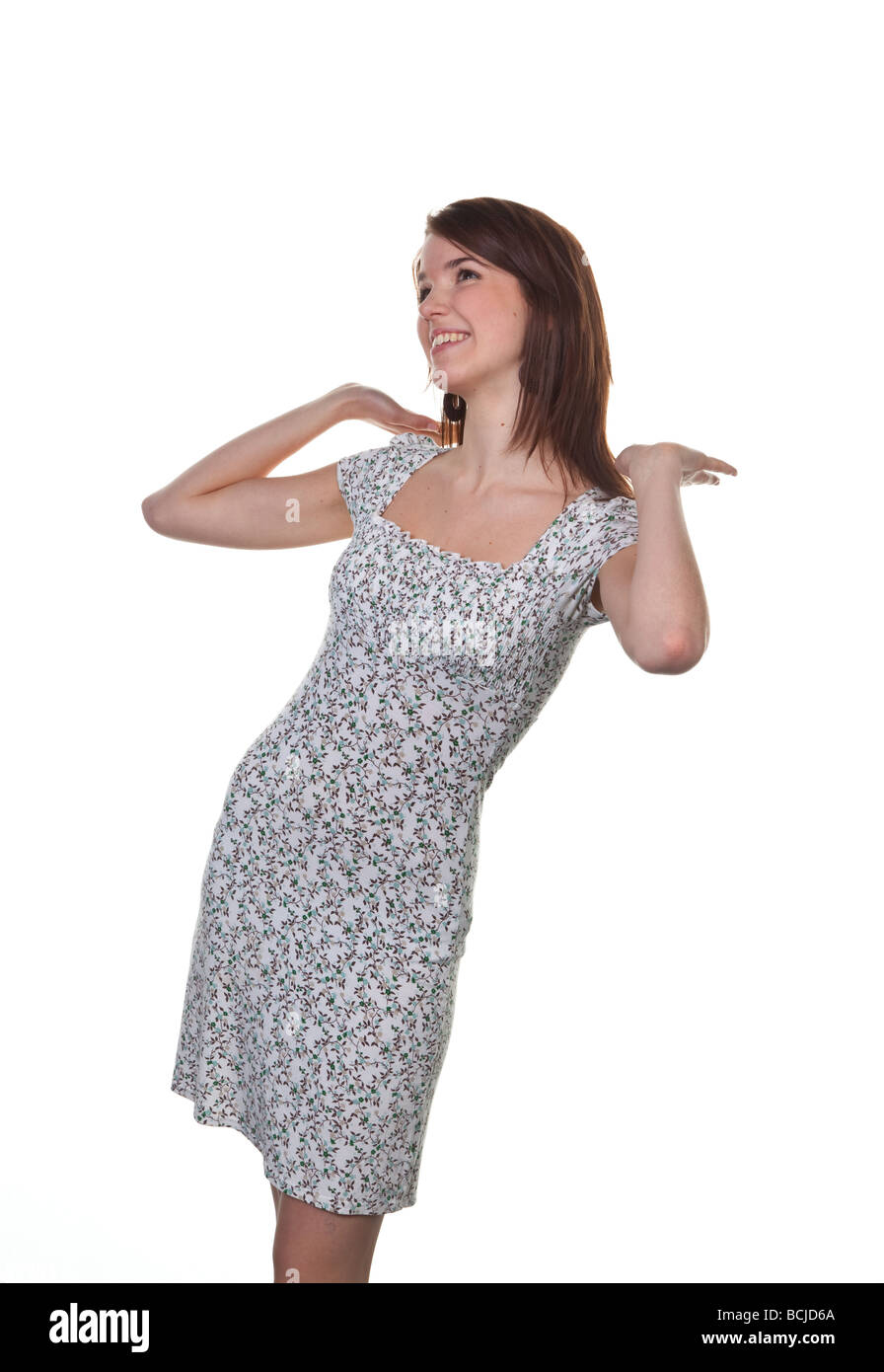 Young girl in a dress exercises posing in front of the camera Stock Photo