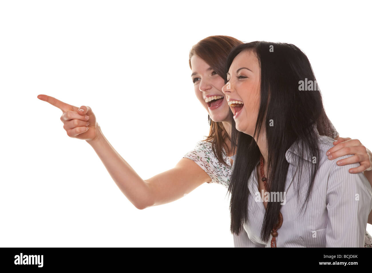 Two young girls see something very funny and laugh Stock Photo - Alamy