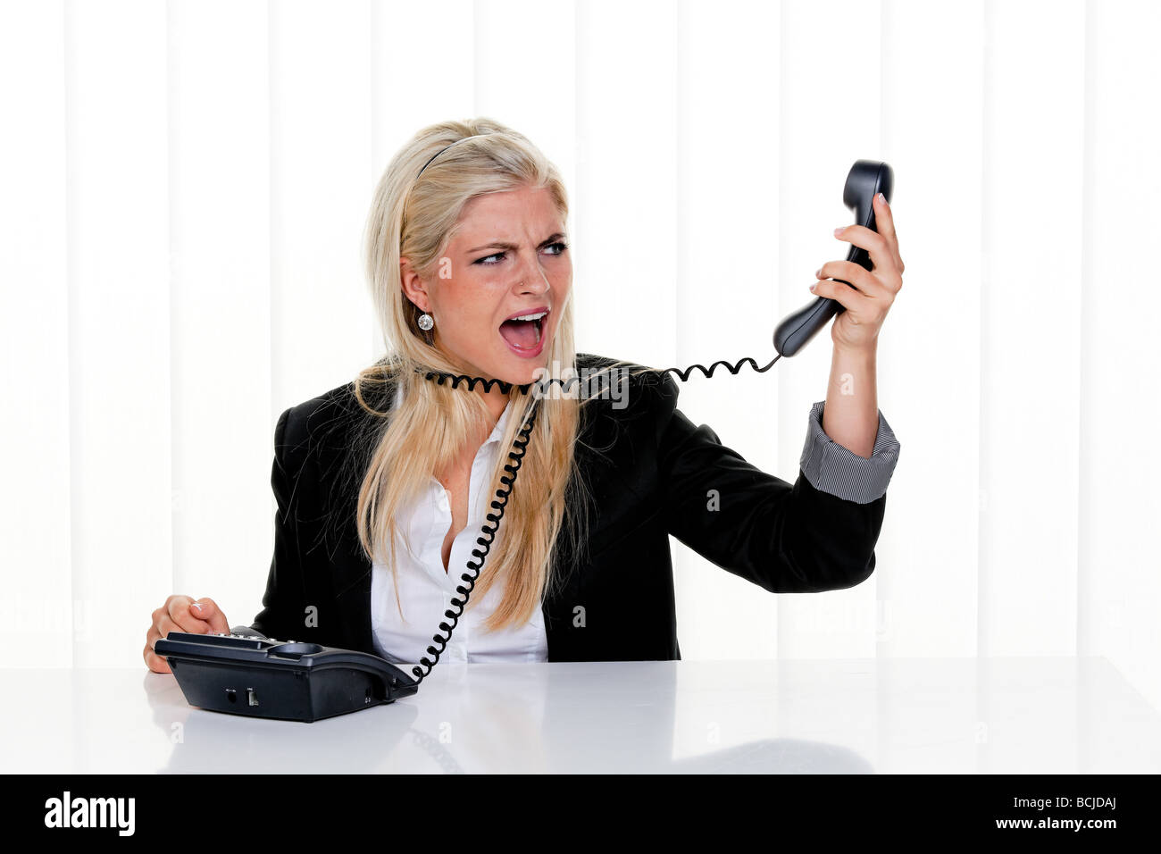 Young woman with problems and stress in the office Stock Photo